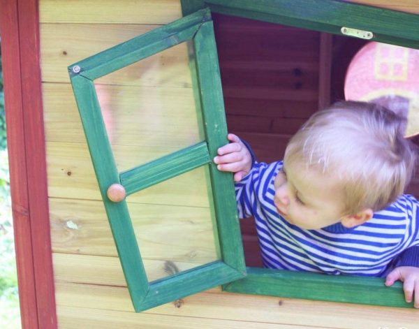 Child Looking Out Of Playhouse Window