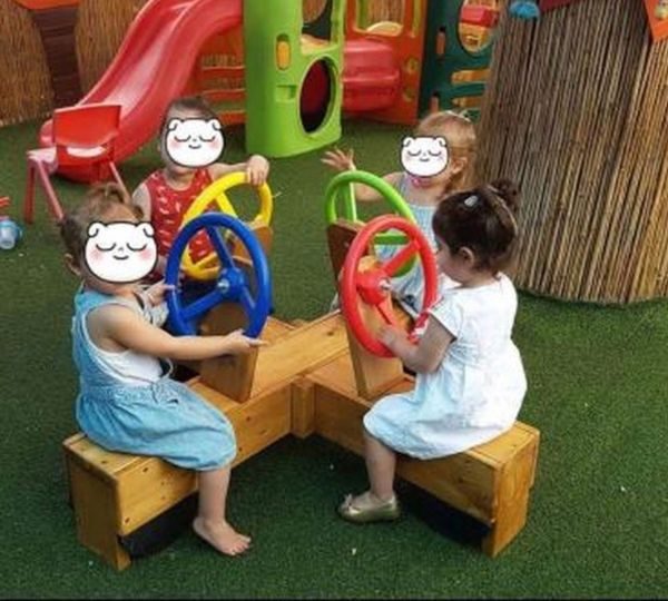 Children Playing On Role Play Circle Rider
