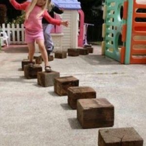 Girl Playing On Wooden Blocks